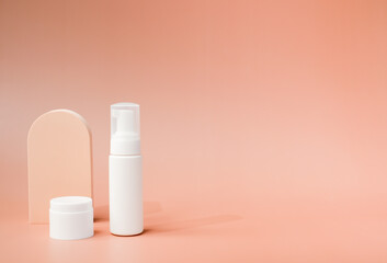 beauty product and mock-up skincare container on a pastel display background with copy space. 