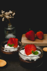 Chocolate pudding with cream and strawberry. Sweet dessert and home cooking.