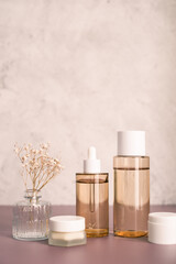 Fototapeta na wymiar skincare set of dropped bottle , jar and toner. self care and cosmetic concept . Vertical beauty background with copy space.