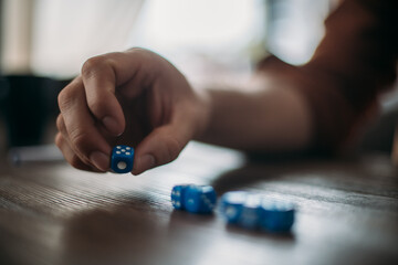 Playing dice and men's hands close-up. Game of dice.