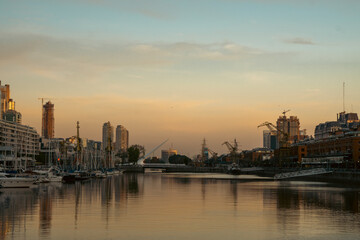 Skyscrapers on the riverside against a sunset backdrop