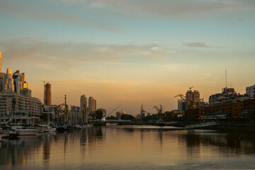 Fototapeta na wymiar Skyscrapers on the riverside against a sunset backdrop
