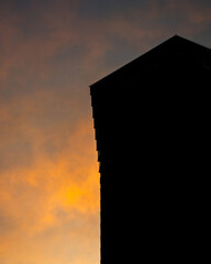 A silhouette of skyscrapers against a sunset backdrop