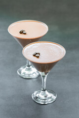 Coffee cream jelly dessert. Panna Cotta in a martini glass. Dark grey background