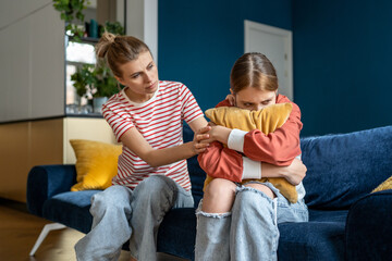 Mother supporting child upset teen girl during difficult adolescence stage, loving parent...