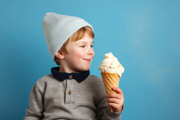 Cute boy kid holding vanilla ice cream in a waffle cone isolated on a blue background. High quality photo Generative AI