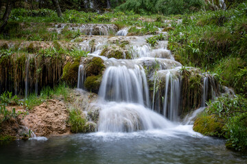 Fototapeta na wymiar Waterfalls of the source of the Cuervo River in the Serrania de Cuenca natural park in Cuenca, Spain