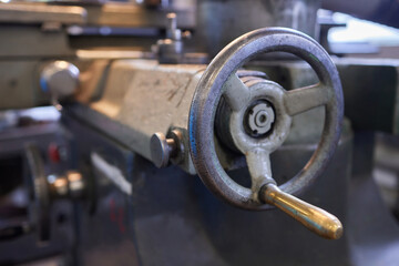 Close up hand heavy industrial worker is working on metal work factory process by performing...