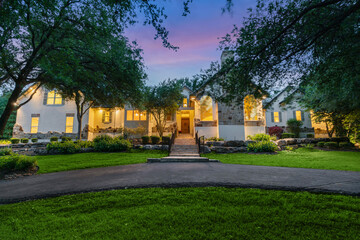 home at sunset with large trees