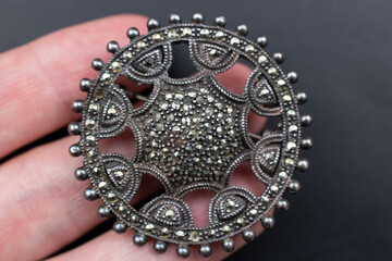 Statement crystal brooch on a black background, vintage jewelry concept, promotional photo for an online jewellery store