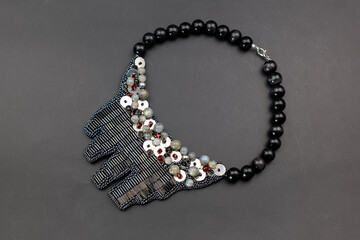 Gray gemstone crystal bead embroidery necklace on black, unique handmade jewelry background