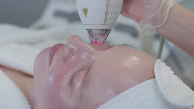 Cosmetology - vacuum facial cleansing for a young woman