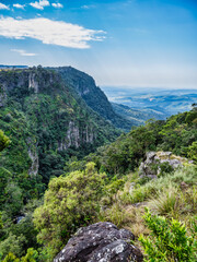 Fototapeta na wymiar Vertical shot of Driekop Gorge and lush foliage during afternoon, Graskop, Mpumalanga, South Africa