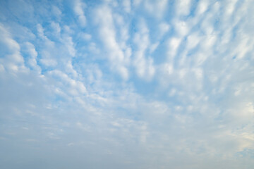Clear blue sky with white fluffy clouds at noon. Day time. Abstract nature landscape background.