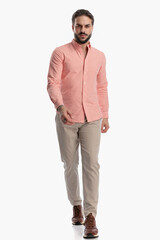 Fototapeta premium unshaved young man with beard in plaid shirt being confident and walking