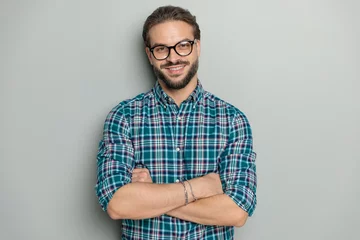 Fotobehang happy nerd man with glasses crossing arms and smiling © Viorel Sima