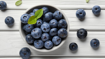 Naklejka na ściany i meble Fresh ripe blueberries with leaves in bowl on white wooden planks - generative ai