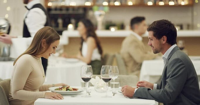 Love, waiter with food or couple in restaurant in celebration of a happy marriage anniversary at dinner at night. Romantic man or woman fine dining eating or bonding on wine date on valentines day