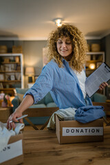 One young adult woman prepare wardrobe clothes for charity donation