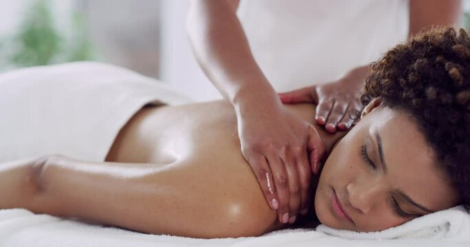 African woman, back massage or relax at spa for treatment, wellness or rest with peace on bed. Girl, masseuse hands and physical therapy for stress, muscle or satisfaction at hotel, resort or holiday