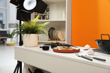 Professional equipment and composition with delicious meat medallion on white table in studio. Food photography