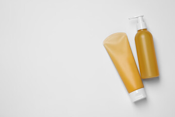 Different cleansers on white background, flat lay with space for text. Cosmetic product