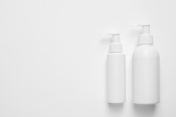 Different cleansers on white background, flat lay with space for text. Cosmetic product