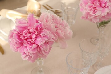 Stylish table setting with beautiful peonies. Space for text
