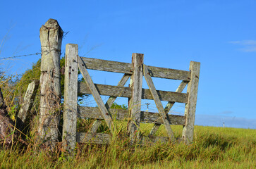 Rustic rural farm gate overlooking a beautiful blue sky