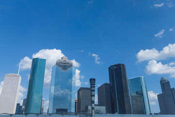 photo of the Houston downtown skyline with clouds in the background.