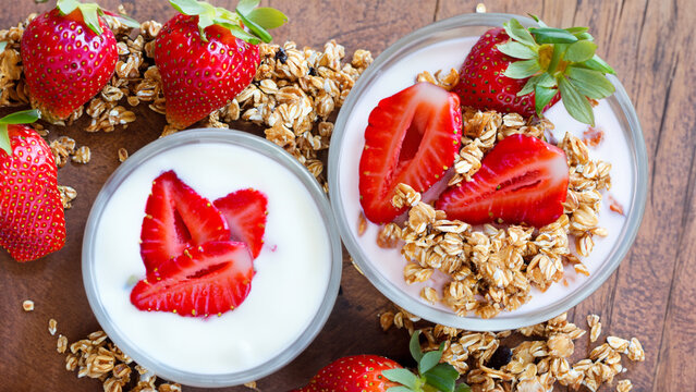 Yogurt and granola with strawberries for breakfast - generative ai