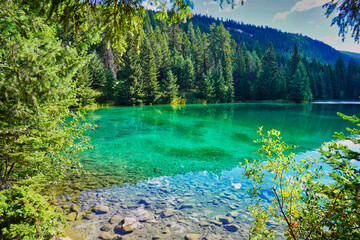 Emerald green shades of the lake waters in the Valley of Five Lakes region trek near Jasper in the Canada Rockies