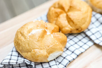 Kaiser rolls with napkin on table, closeup