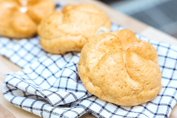 Kaiser rolls with napkin on table, closeup