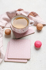 Drink coasters with cup of tea and macaroons on white table