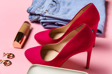 Stylish heels, clothes, earrings and liquid foundation on pink background, closeup