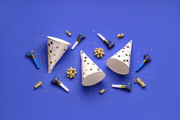 Party hats and whistles on dark blue background