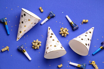 Party hats and whistles on dark blue background