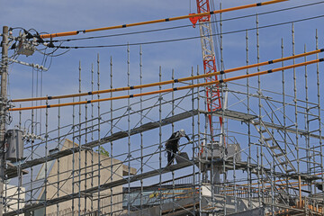 worker move on a  scaffolding in the construction site of building near Shinjuku.