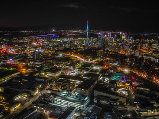 Auckland Skyline at Night. Aerial view of the downtown landmarks, Sky Tower, Harbour Bridge, highways and CBD shinning bright. 
