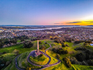Monument on One Tree Hill, in Cornwall Public Park, Auckland. Sunset colours and city...