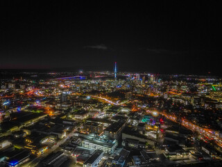 Fototapeta premium Auckland Skyline at Night. Aerial view of the downtown landmarks, Sky Tower, Harbour Bridge, highways and CBD shinning bright. 