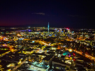 Auckland Skyline at Night. Aerial view of the downtown landmarks, Sky Tower, Harbour Bridge, highways and CBD shinning bright. 
