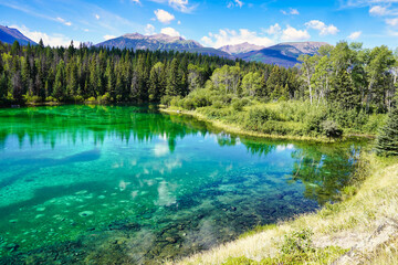 Crystal clear, emerald and sapphire hued lake waters in the Valley of Five Lakes region of Jasper in the Canada Rockies