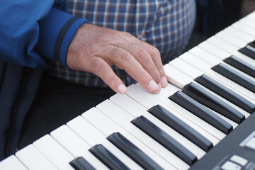  men hands playing grand piano