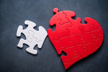 Puzzle jigsaw heart on brain mental health concept