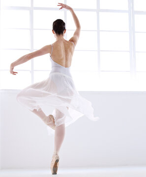 Dance, ballet and creative with woman in studio for balance, elegant and performance. Artist, theatre and training with female ballerina dancing in class for competition, freedom and commitment