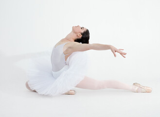 Theatre, dance and ballet with a woman in studio on a white background for rehearsal or recital for a dancing performance. Art, creative and expression with a young ballerina or dancer in uniform