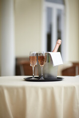 Hotel, bottle and glasses of champagne on a table for luxury service, celebration and hospitality....
