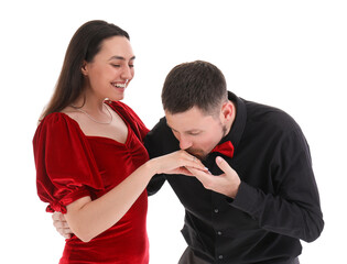 Young man kissing his girlfriend's hand with engagement ring on white background